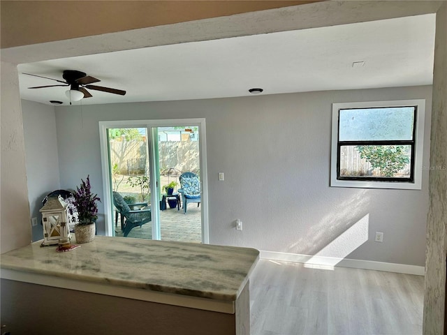 bedroom with multiple windows, ceiling fan, access to exterior, and light hardwood / wood-style floors