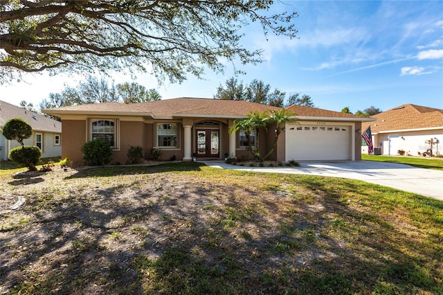 ranch-style house with a garage and a front lawn