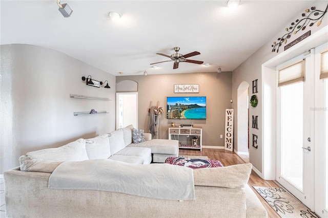 living room with light hardwood / wood-style flooring and ceiling fan