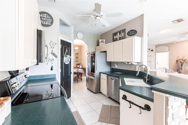 kitchen featuring white cabinetry, sink, light tile patterned floors, ceiling fan, and stainless steel appliances