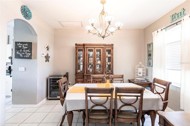 dining room with wine cooler, a chandelier, and light tile patterned floors