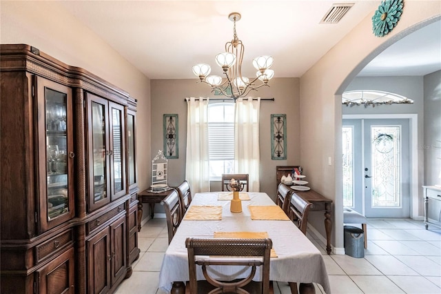 dining area featuring an inviting chandelier and light tile patterned flooring