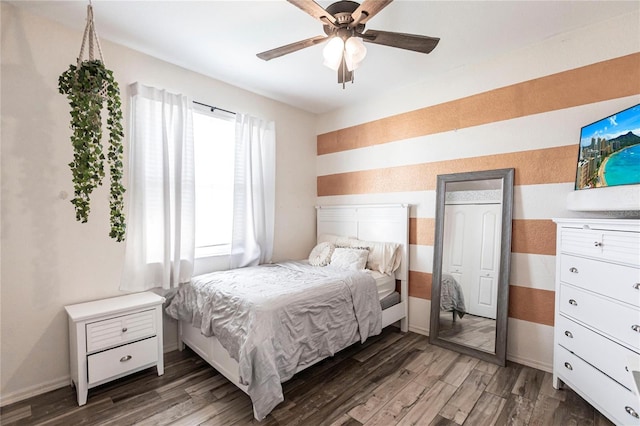 bedroom with dark wood-type flooring and ceiling fan