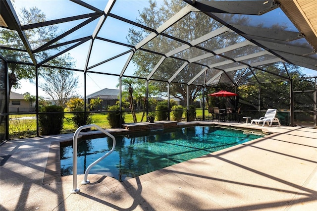 view of pool with a patio and glass enclosure