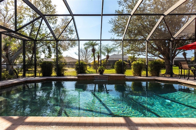 view of pool featuring a patio area and glass enclosure