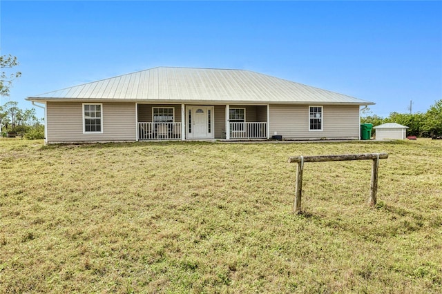 ranch-style home with a garage, an outdoor structure, a front lawn, and covered porch