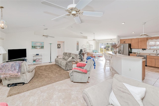 tiled living room with ceiling fan, lofted ceiling, and sink