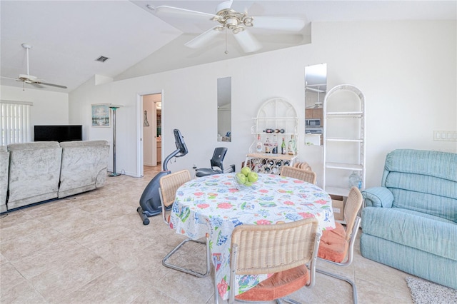 dining room with ceiling fan and vaulted ceiling