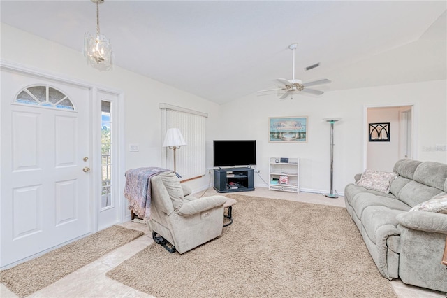 living room with light colored carpet, lofted ceiling, and ceiling fan with notable chandelier