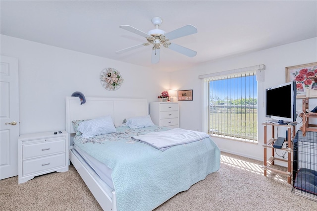 bedroom with ceiling fan and light carpet