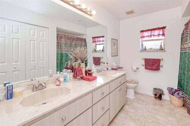 bathroom with tile patterned flooring, vanity, and toilet