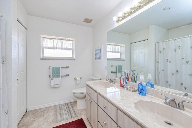 bathroom featuring tile patterned floors, vanity, and toilet