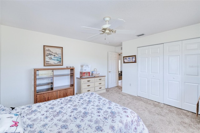 carpeted bedroom featuring a closet and ceiling fan