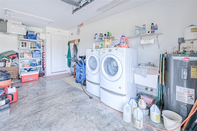 laundry room featuring washer and dryer, sink, and water heater