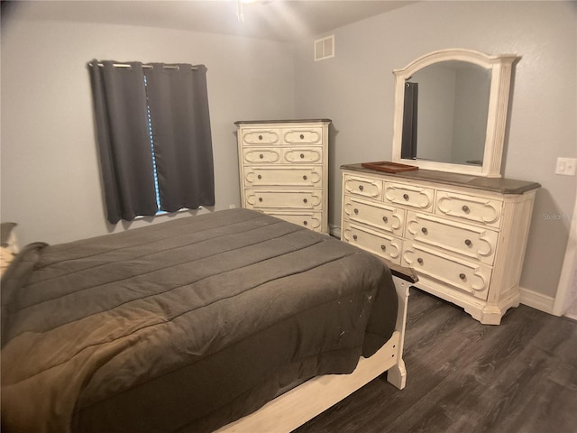 bedroom with dark hardwood / wood-style floors