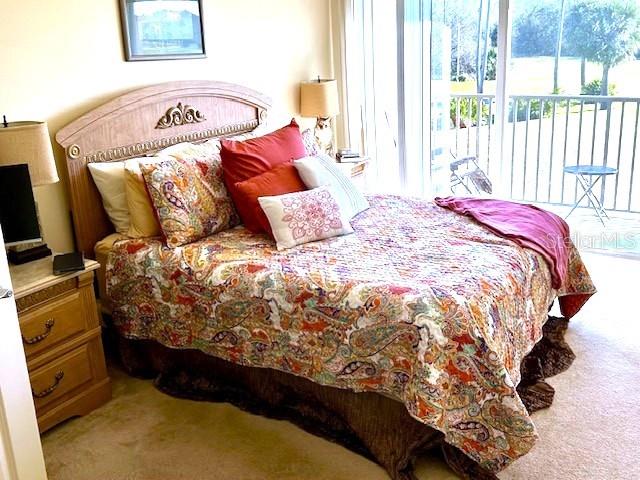 carpeted bedroom with access to outside