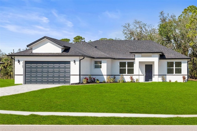 view of front of house featuring a garage and a front lawn