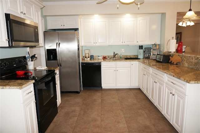 kitchen with hanging light fixtures, black appliances, and white cabinets