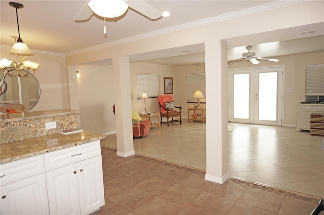 kitchen with pendant lighting, white cabinetry, light tile patterned floors, crown molding, and french doors