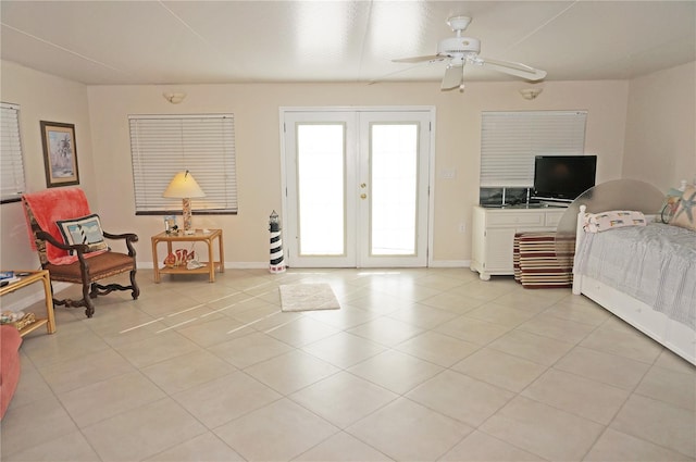 tiled bedroom with french doors, ceiling fan, and access to exterior