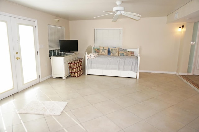 tiled bedroom with ceiling fan and french doors