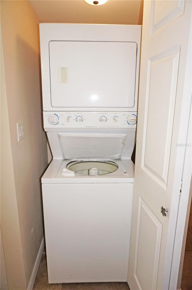 clothes washing area with stacked washer and dryer