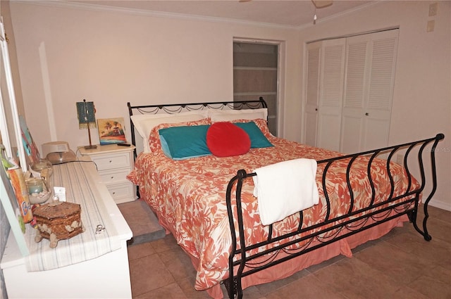 bedroom with tile patterned flooring, ornamental molding, and a closet