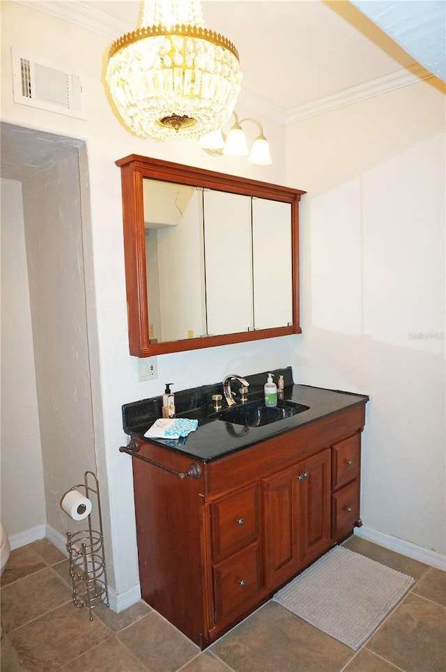 bathroom with vanity, tile patterned flooring, crown molding, and an inviting chandelier