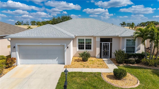 single story home featuring a garage and a front lawn