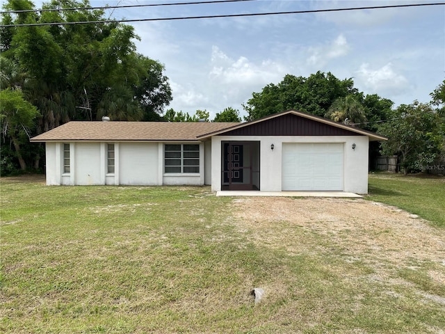 ranch-style house featuring a garage and a front yard