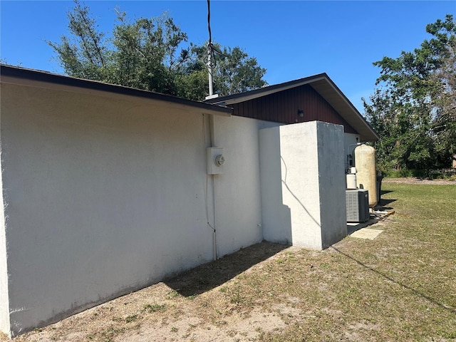 view of property exterior featuring a yard and central AC unit