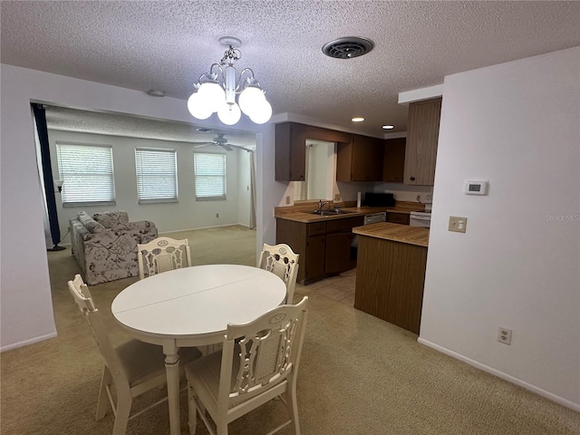 432 Olivia Rd, Venice, FL 34293 - dining space with light colored carpet, a textured ceiling, and a chandelier