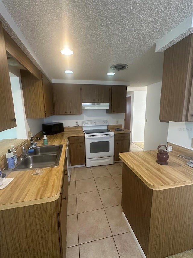 432 Olivia Rd, Venice, FL 34293 - kitchen with white electric range, under cabinet range hood, black microwave, a textured ceiling, and butcher block countertops