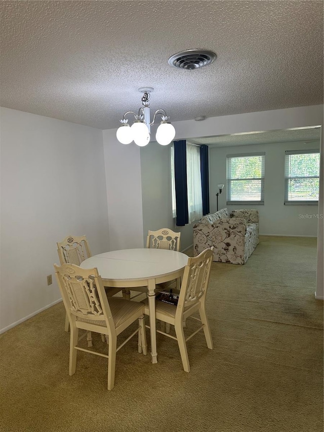 432 Olivia Rd, Venice, FL 34293 - dining room with carpet flooring, a textured ceiling, and a chandelier