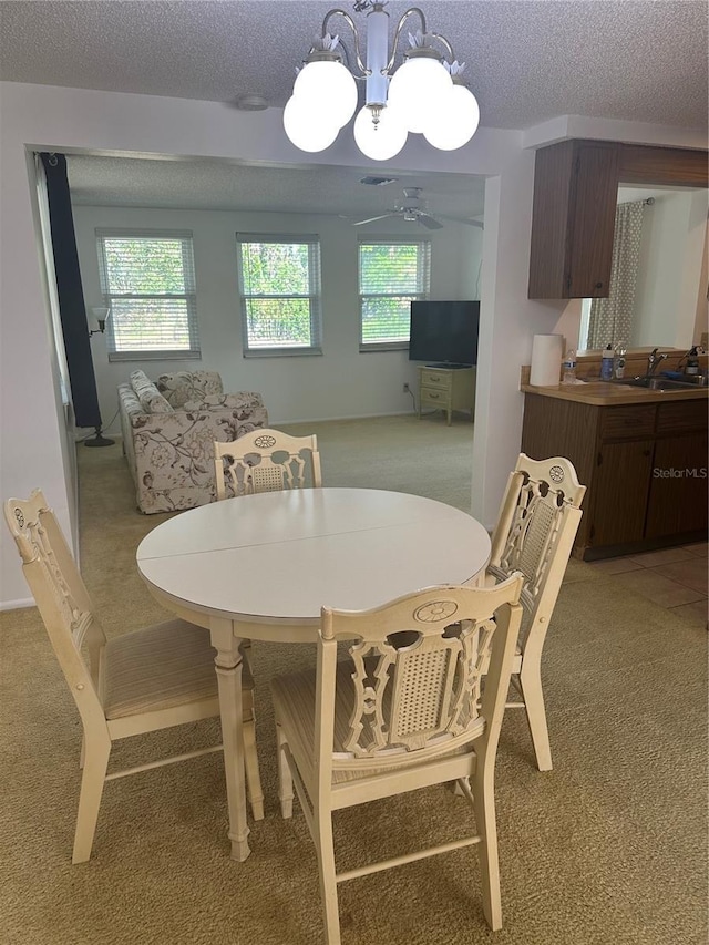 432 Olivia Rd, Venice, FL 34293 - dining area with light carpet, plenty of natural light, a ceiling fan, a textured ceiling, and a chandelier