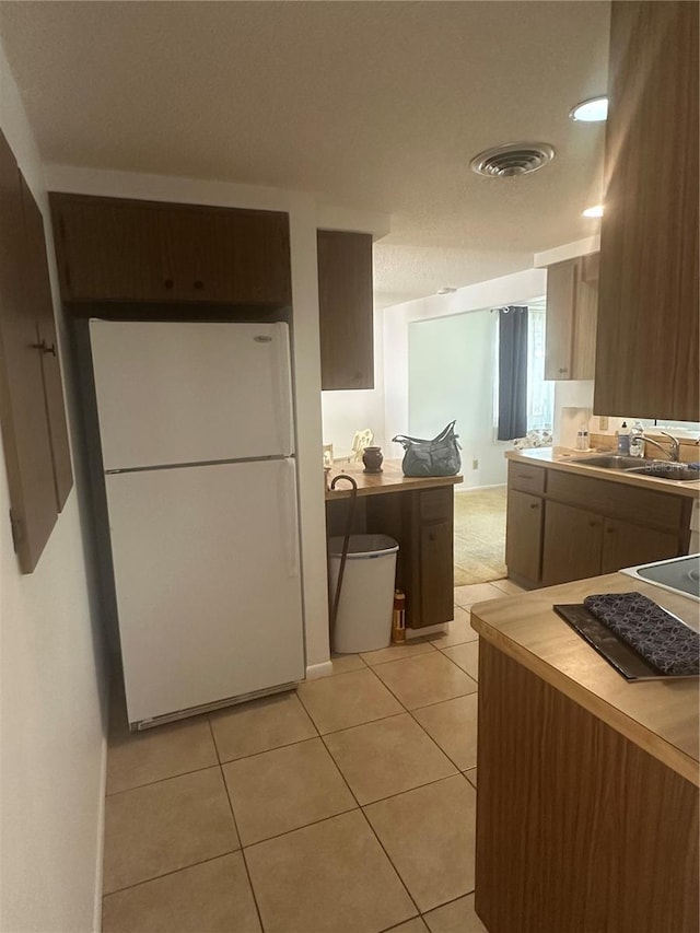 432 Olivia Rd, Venice, FL 34293 - kitchen with freestanding refrigerator, light tile patterned floors, and light countertops
