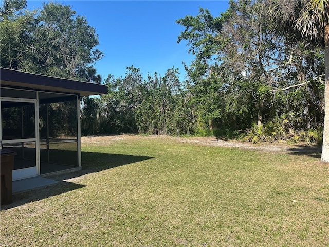 432 Olivia Rd, Venice, FL 34293 - view of green lawn with a sunroom