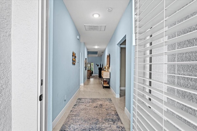 hallway featuring light tile patterned floors