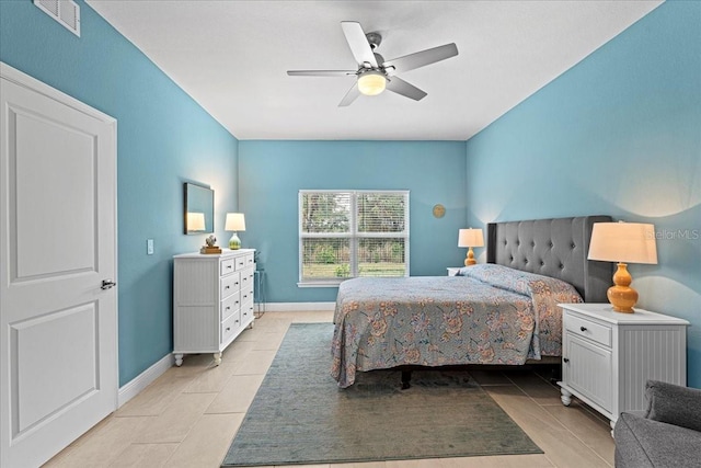 tiled bedroom featuring ceiling fan