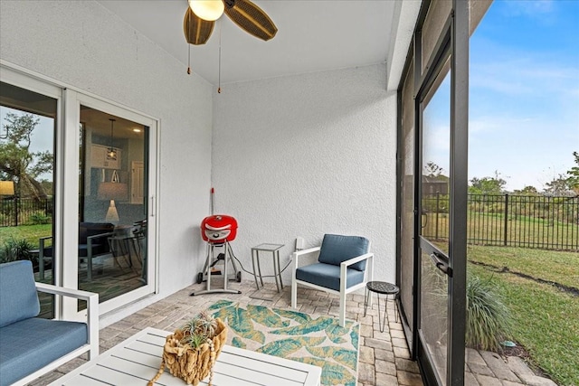 sunroom with ceiling fan and a healthy amount of sunlight