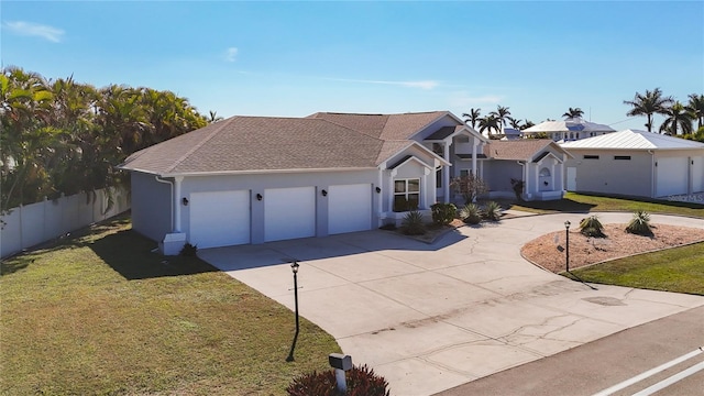 view of front of home featuring a garage and a front lawn