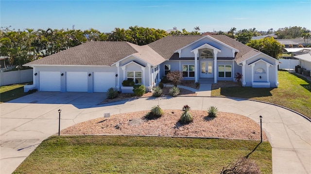 single story home with a garage and a front lawn