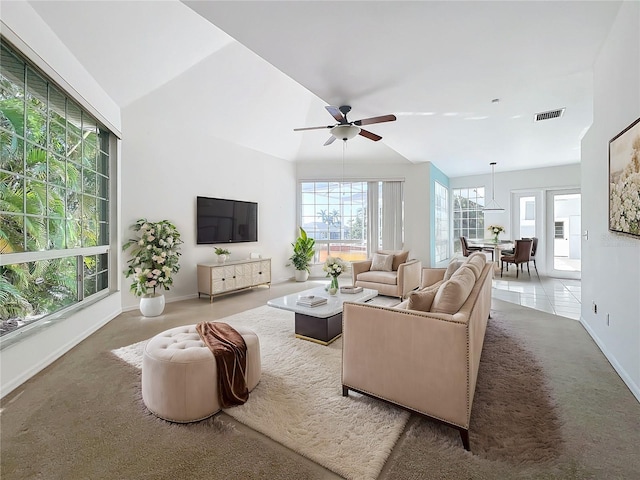 carpeted living room featuring ceiling fan and vaulted ceiling