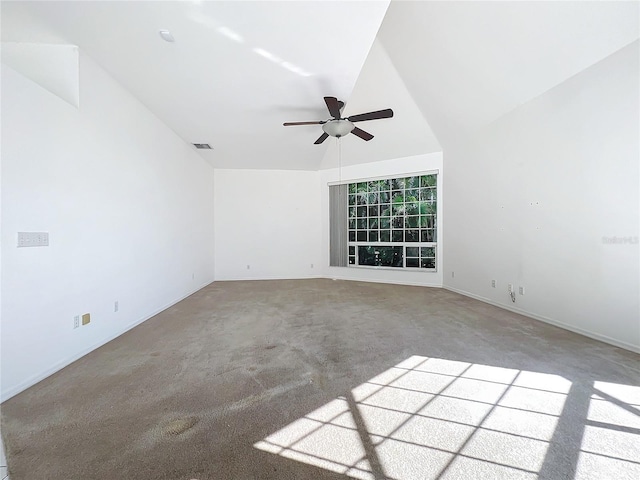 carpeted spare room with vaulted ceiling and ceiling fan