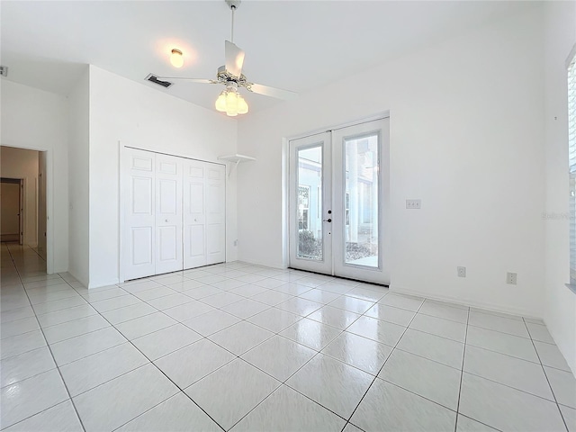 interior space with french doors and ceiling fan