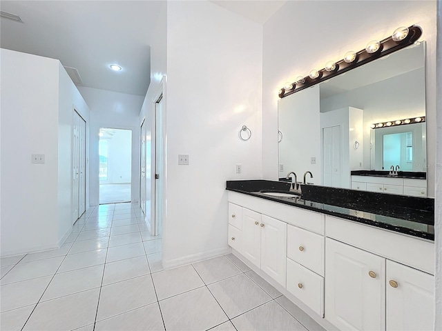 bathroom with tile patterned flooring and vanity