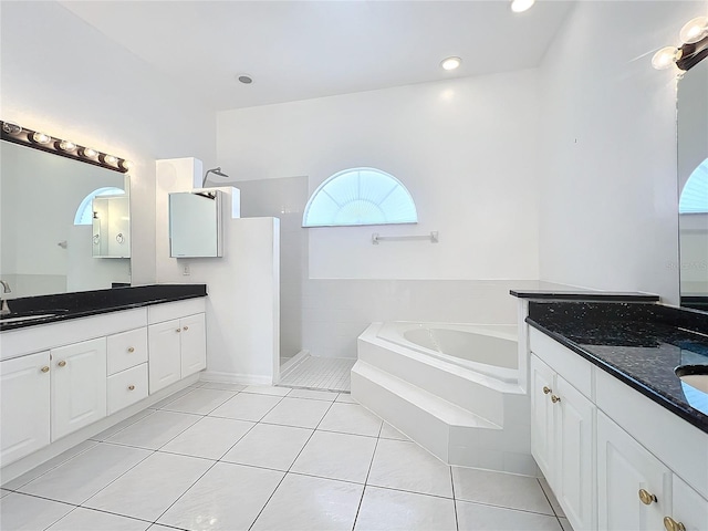 bathroom with tile patterned flooring, vanity, and shower with separate bathtub