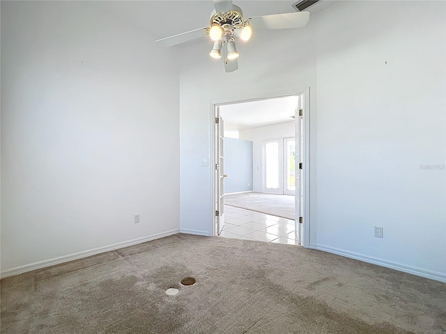 carpeted empty room featuring ceiling fan