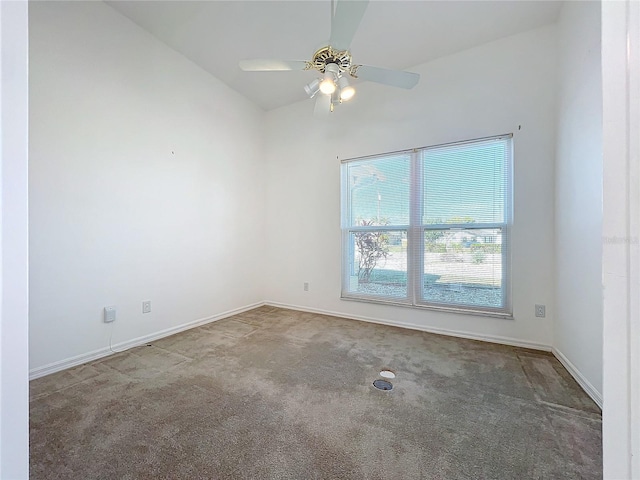 carpeted spare room featuring ceiling fan and vaulted ceiling