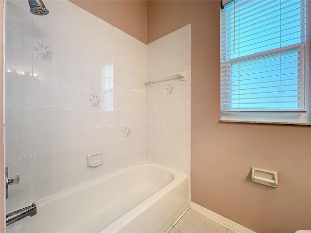 bathroom featuring tiled shower / bath and tile patterned floors